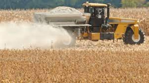 Lime spreader applying lime. 