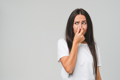 Woman reacting to an offensive smell