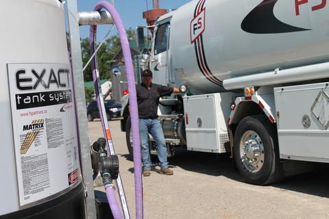 Driver filling up an EXACT Tank System.