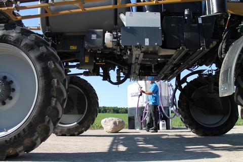 sprayer pulled up beside an EXACT Tank System